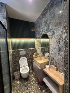 a bathroom with a toilet and a sink and a mirror at Stylish Loft Apartment with Private Terrace in Erdemli +61 photos