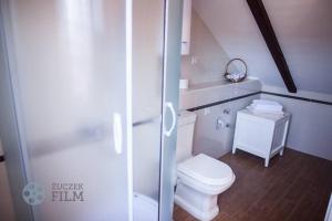 a white bathroom with a toilet and a shower at Villa Agava in Vrboska