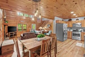 a kitchen and living room with a wooden ceiling at Among The Trees in Vilas