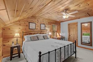 a bedroom with a bed in a room with wooden ceilings at Among The Trees in Vilas