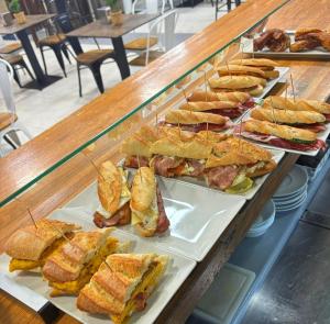a bunch of sandwiches on plates in a display case at Habitaciones triple familiar HOTEL LAUAXETA in Mungia +5 photos