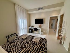 a bedroom with a bed and a desk and a television at Salotto Santa Franca in Piacenza +106 photos