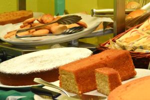 a table topped with cakes and pastries at Albergo Martini in Chianciano Terme