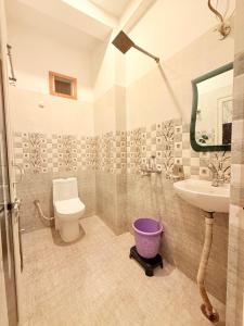 a bathroom with a toilet and a sink at LA VACA Casa in Varanasi