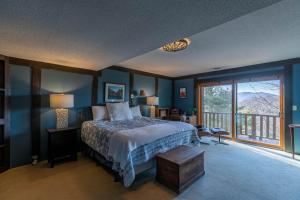 a bedroom with a bed and a large window at On Any Sunday in Blowing Rock