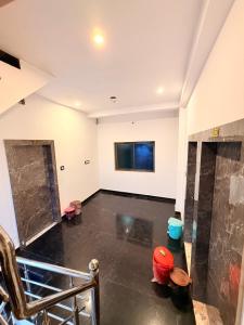 an empty room with a black floor and white walls at LA VACA Casa in Varanasi +46 photos