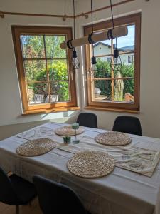 a table with three plates on it with two windows at Haus am Fluss in Kirchberg am Wechsel +6 photos