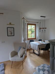 a dining room with a table and chairs and a window at Haus am Fluss in Kirchberg am Wechsel