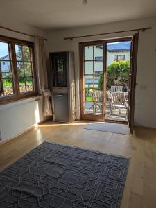 a living room with a door open to a patio at Haus am Fluss in Kirchberg am Wechsel