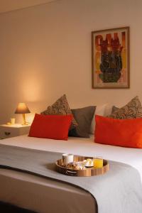 a hotel room with a bed with a tray of food on it at Apartamento con terraza privada junto al Bulevar del Rio in Cali