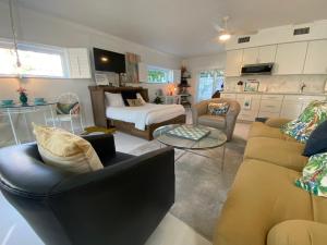 a living room with a couch and a table at Closest Studio Suite to Vanderbilt Beach, remodeled inside & out, new Anderson windows & sliders, well appointed, best quality throughout, fenced yard, private plus many extras! in Naples