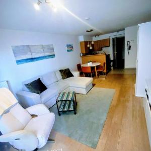 a living room with a white couch and a table at Maison de la mer in Blankenberge