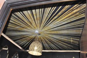 a chandelier hanging from a wall with a fan at SAHARA chic in Reggio di Calabria +47 photos