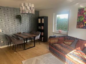 a living room with a couch and a table at Landhaus Falkennest in Flintsbach am Inn