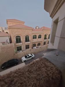 a white car parked in front of a building at The Perfect Cozy Studio In Abu Dhabi in Abu Dhabi