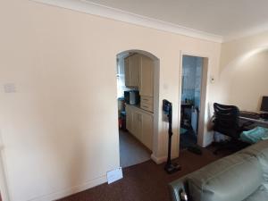 a living room with a couch and a desk at Burton Down Town Apartment in Burton upon Trent