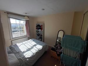a bedroom with a bed and a window at Burton Down Town Apartment in Burton upon Trent
