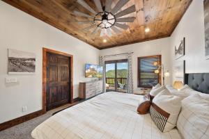 a bedroom with a large bed and a wooden ceiling at Cranberry View Lodge in Newland