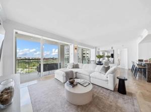 a living room with a white couch and a table at Coconut Grove Elegance Five Star Condo Living in Miami