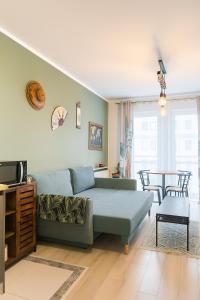 a living room with a couch and a table at Garden Spot and Parking in Krakow