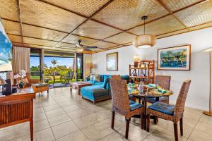 a living room with a table and a couch at Maui Eldorado Condo A104 in Kaanapali