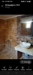 a bathroom with a sink and a mirror at VILLA MAKRI 2 in Mákri
