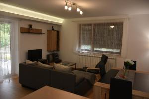 a living room with a couch and a table at Countryside rest house in Novi Banovci