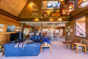 a living room with a blue couch and a tv at Endless Vistas in Seven Devils
