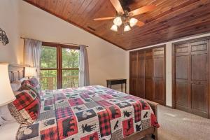 a bedroom with a bed and a ceiling fan at Banner Elk Lodge in Beech Mountain
