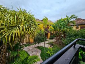 a view from a balcony of a house with palm trees at FLAT ILHA FLAT HOTEL in Ilhabela