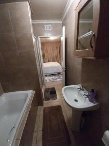 un bagno con lavandino, vasca e WC di Lubsman Apartments a Centurion Altre 41 foto