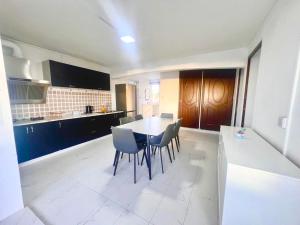 a kitchen with a table and chairs in a room at Soleil Couchant Apt 8 in Flic-en-Flac +1 photo