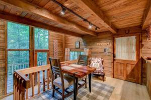 a dining room with a table and chairs in a cabin at The Dog House in Boone