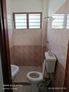 a bathroom with a toilet and a sink at Serviced 4 bedroom apartment in Mombasa +6 photos