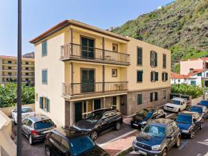 a group of cars parked in a parking lot in front of a building at Ribeira Brava Studios - L in Ribeira Brava