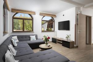 a living room with a couch and a tv at Captain Villa 2 km to the beach in Vintijan