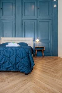 una camera da letto con pareti blu, un letto e un tavolo di B&B Cleyn Cruysenborgh 1531 a Dordrecht