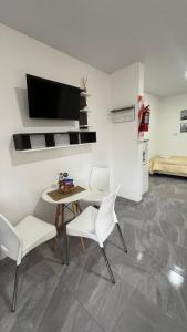 a living room with a table and two chairs at Dormis Bajos Medanales in Victorica
