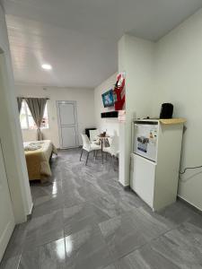 a living room with a refrigerator and a table at Dormis Bajos Medanales in Victorica