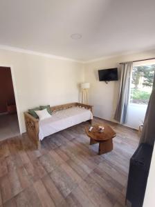 a bedroom with a bed and a coffee table at Cabañas Del Lolo in Villa Ventana +39 photos