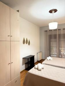 a bedroom with two beds and a black table at Ericius House in Ierissos