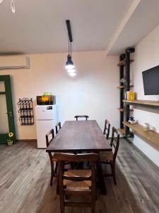 a dining room with a wooden table and chairs at Villa Lilli Beta Bella in Neive +17 photos