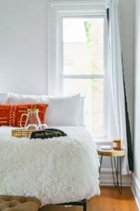 a bedroom with a white bed and a window at Prime Location Top Rated Clean Parking Free! in Columbus +56 photos