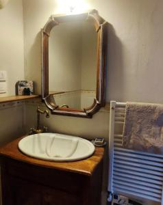 a bathroom with a sink and a mirror at HILL's ROOM in Vescona