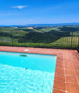 a swimming pool with a view of the countryside at HILL's ROOM in Vescona