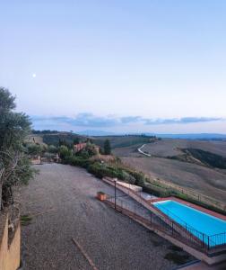 a house with a swimming pool and the ocean at HILL's ROOM in Vescona