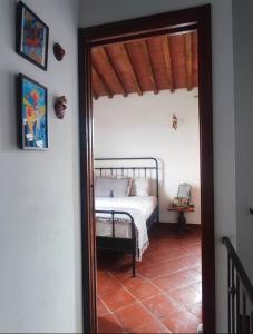 a bedroom with a bed and a mirror at HILL's ROOM in Vescona