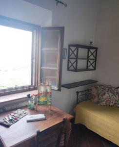 a room with a desk and a bed and a window at HILL's ROOM in Vescona +11 photos