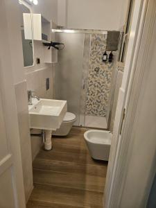 a bathroom with a sink and a toilet and a shower at Palazzo Gentile in Reggio Calabria