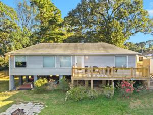 a house with a porch with a deck at Tara's Riverfront Hideaway in Mobile